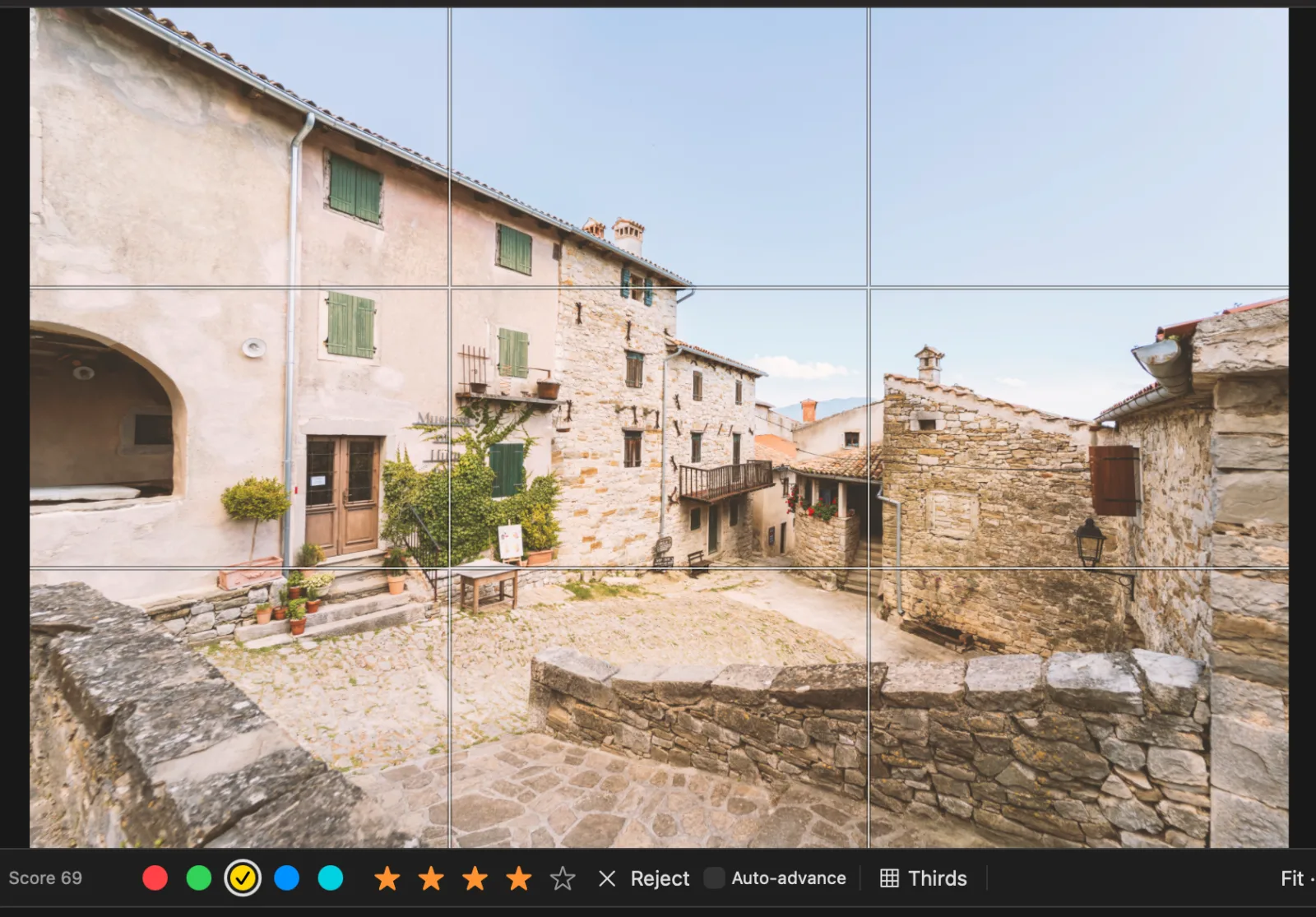 The rule-of-thirds overlay over a photo of a village square in the Loupe